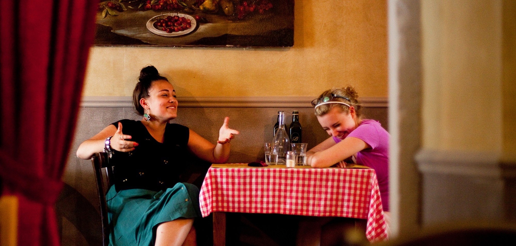 Two women at a restaurant plan a gap semester