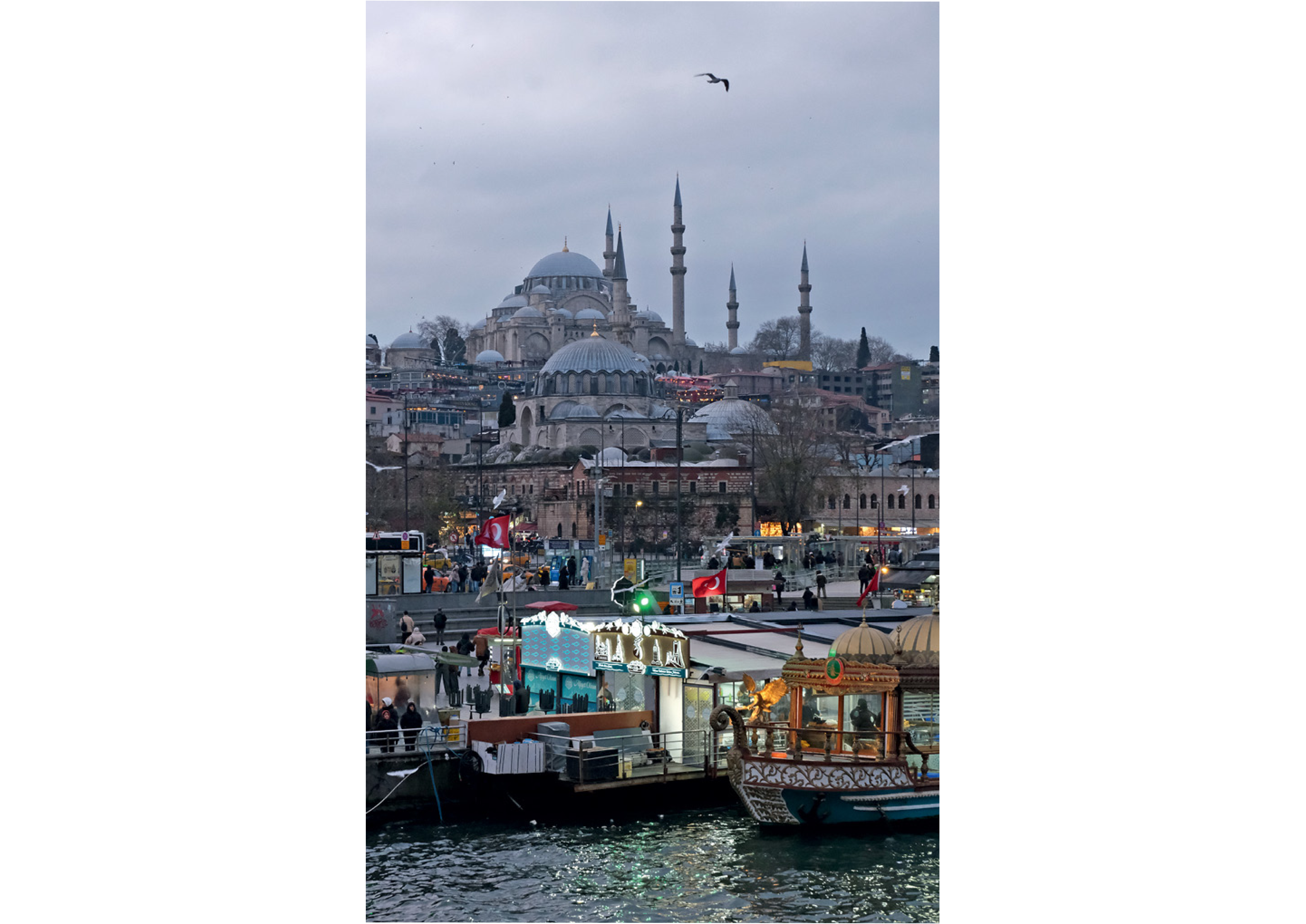 A bustling waterfront scene at dusk with a mosque in the background, food stalls, and boats on the water, under a cloudy sky with a lone bird flying.