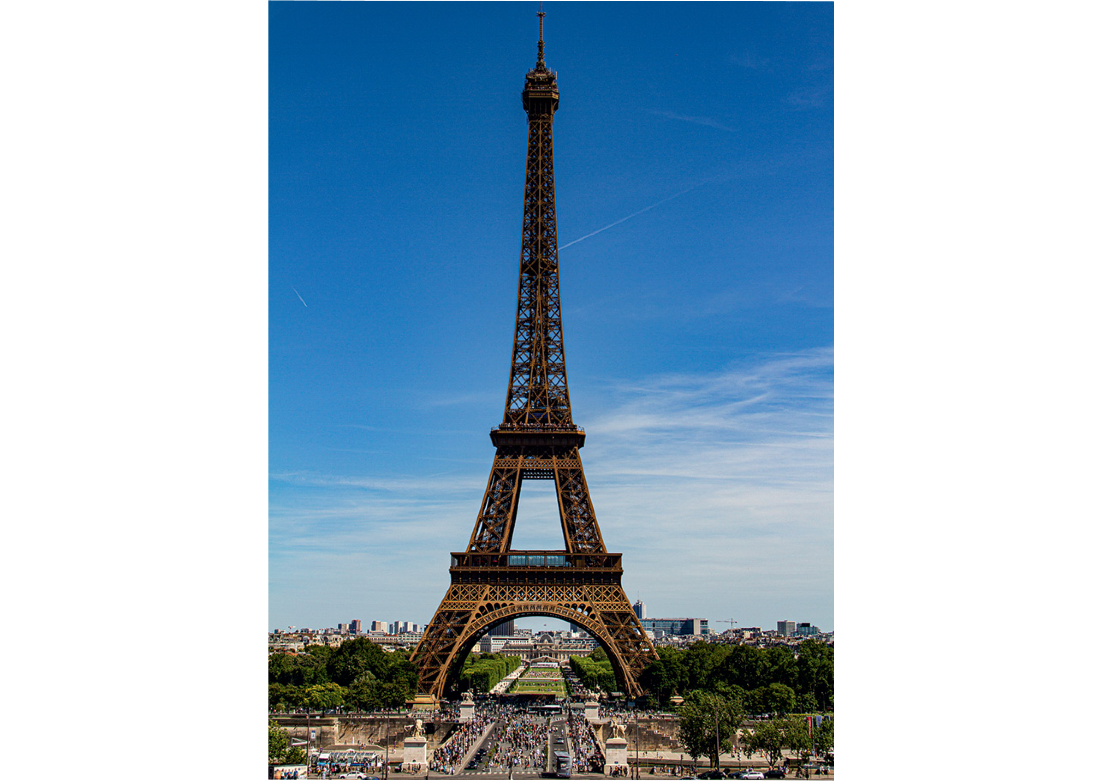 Eiffel The Eiffel Tower against a clear blue sky, with tourists visible at the base and Paris cityscape in the background.