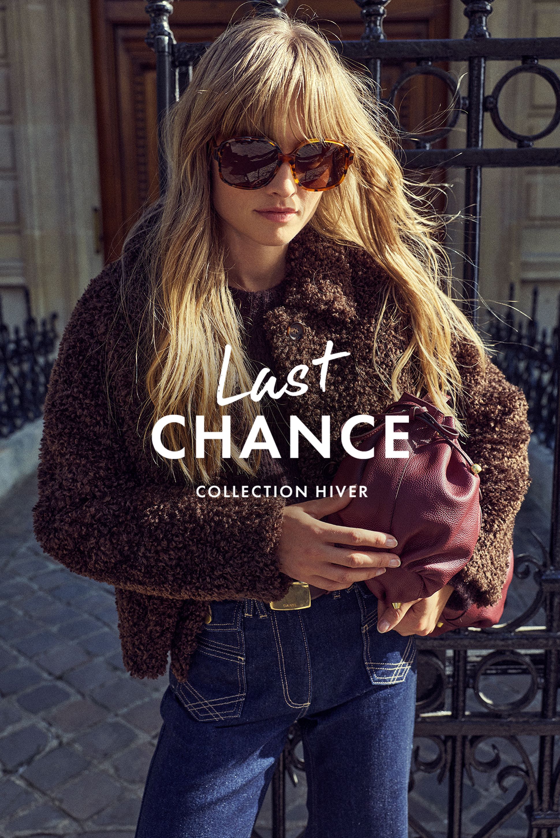 Woman in a brown textured coat and sunglasses holds a maroon purse. Text reads "Last Chance Collection Hiver." Background features ornate ironwork.