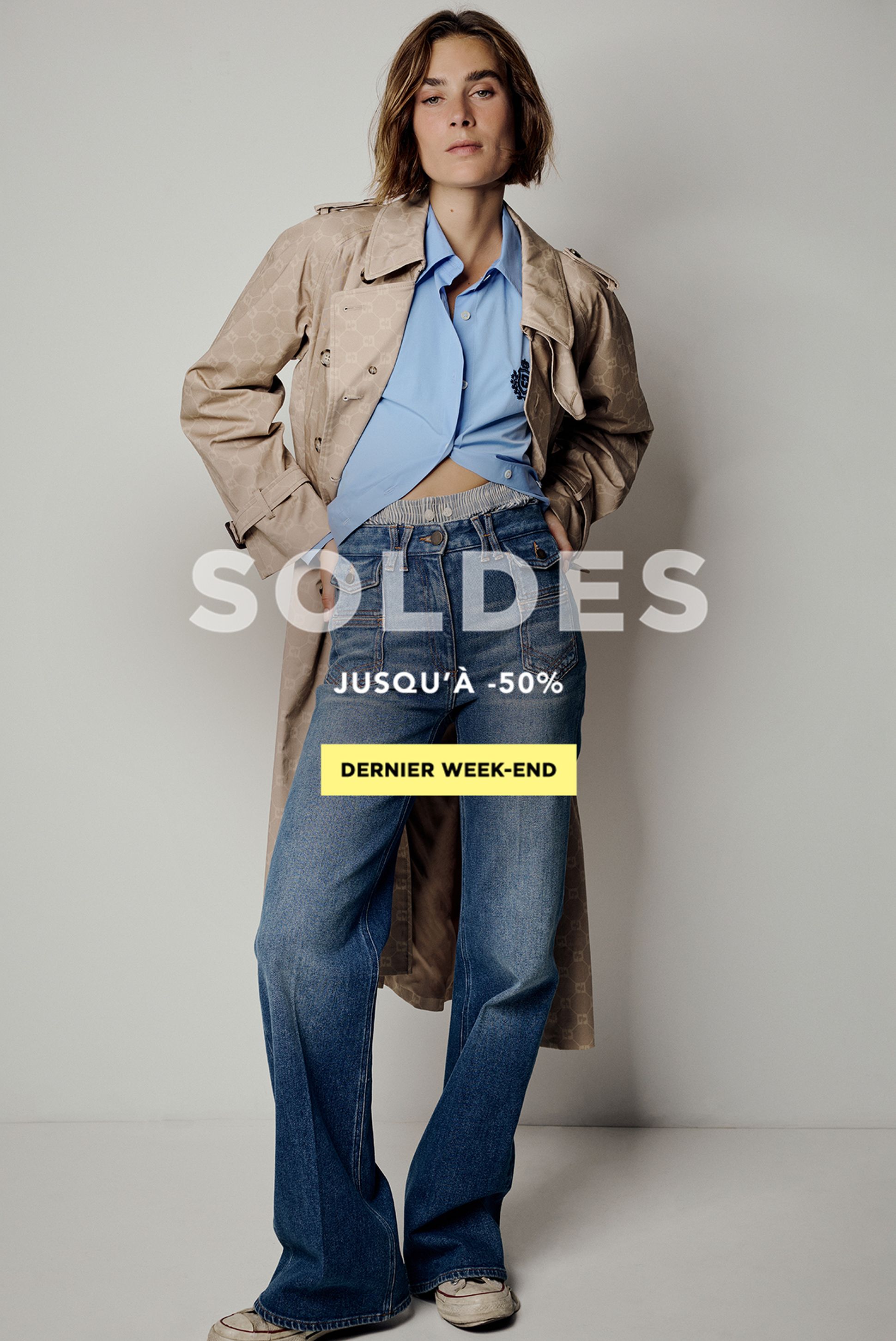 Woman in a trench coat over a blue shirt and jeans, promoting a sale up to 50% off, labeled "Dernier Week-End."