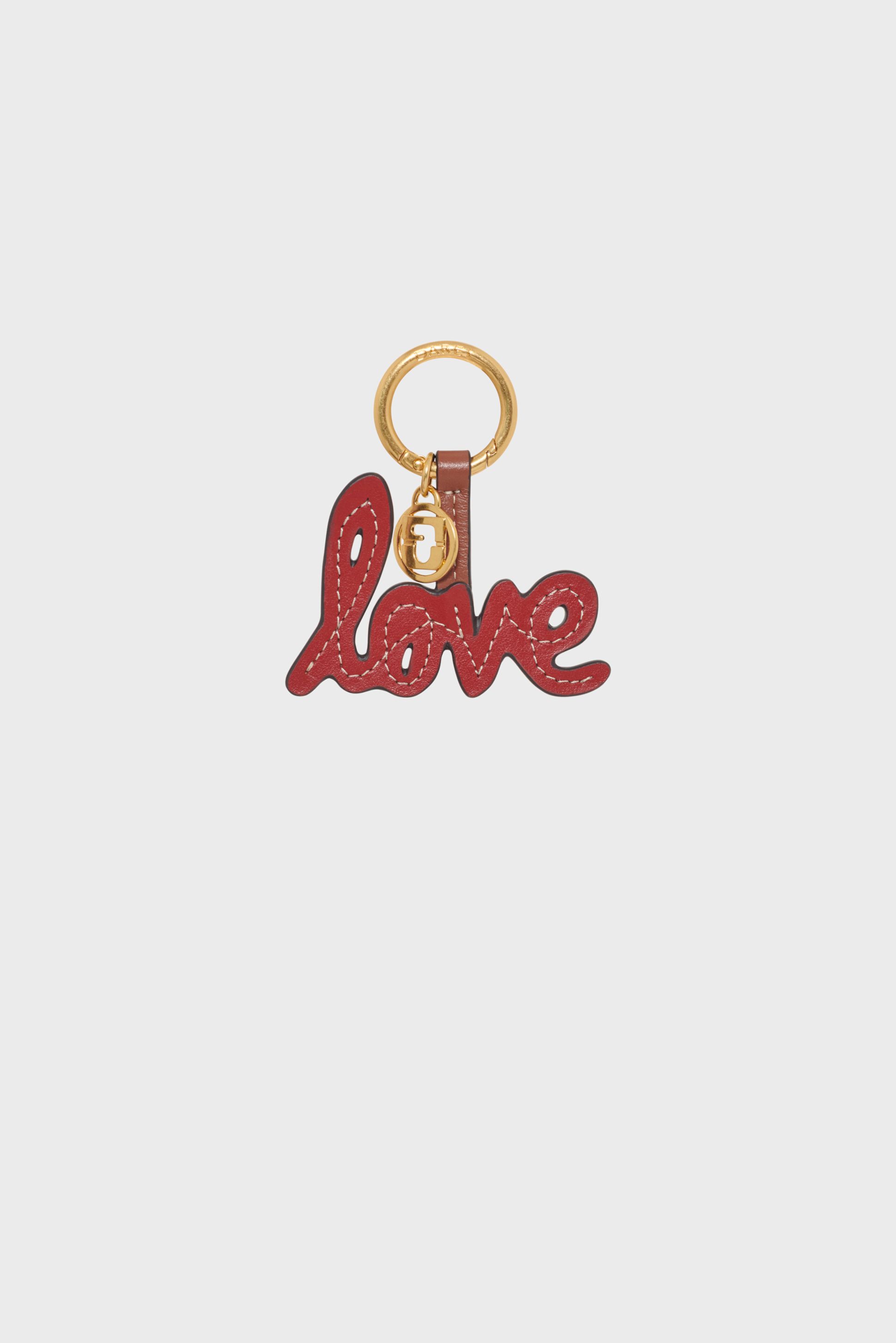 Red leather keychain with the word "love" in cursive letters, attached to a gold ring.