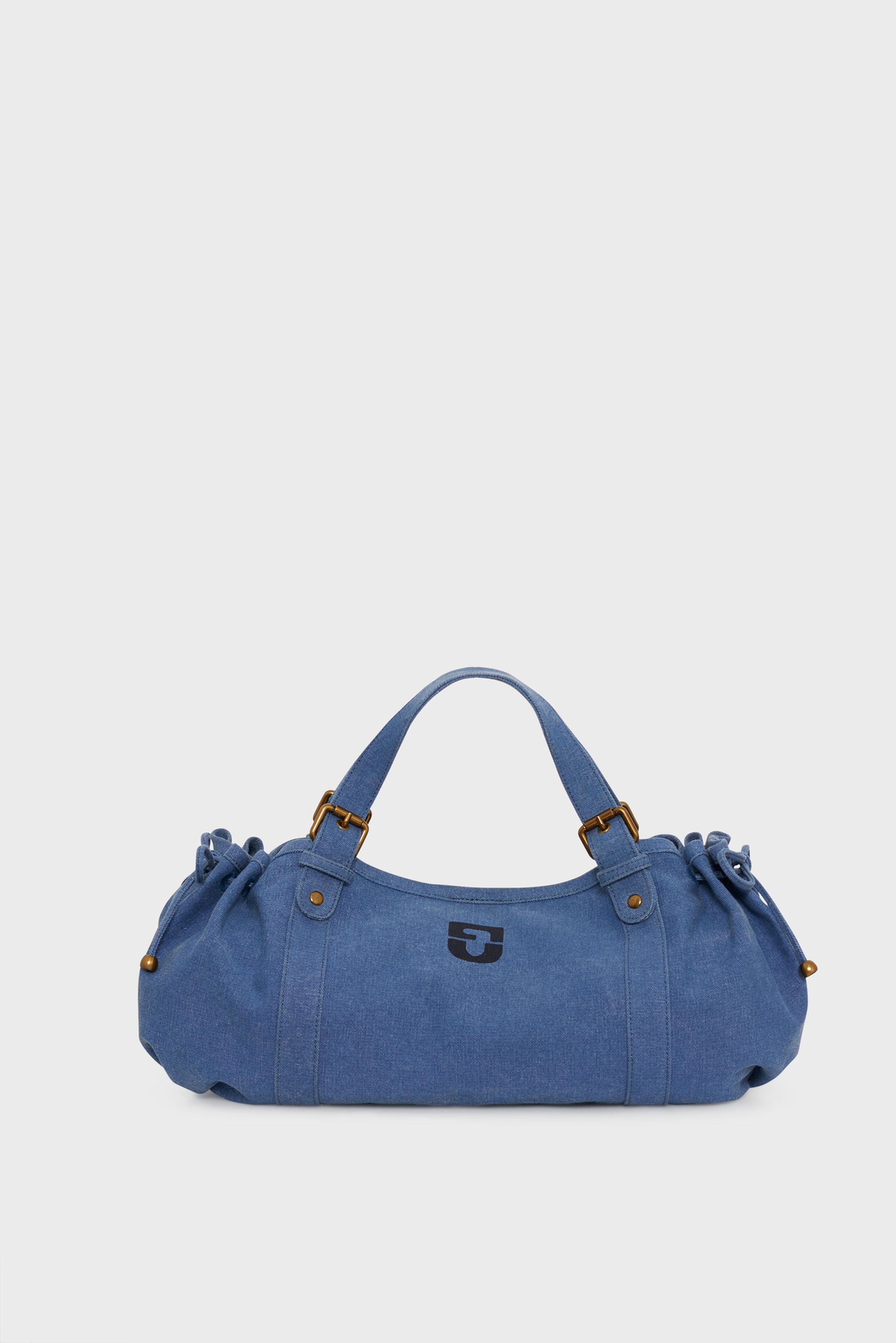 Blue denim barrel bag with short handles and drawstring sides, featuring a small emblem on the front.