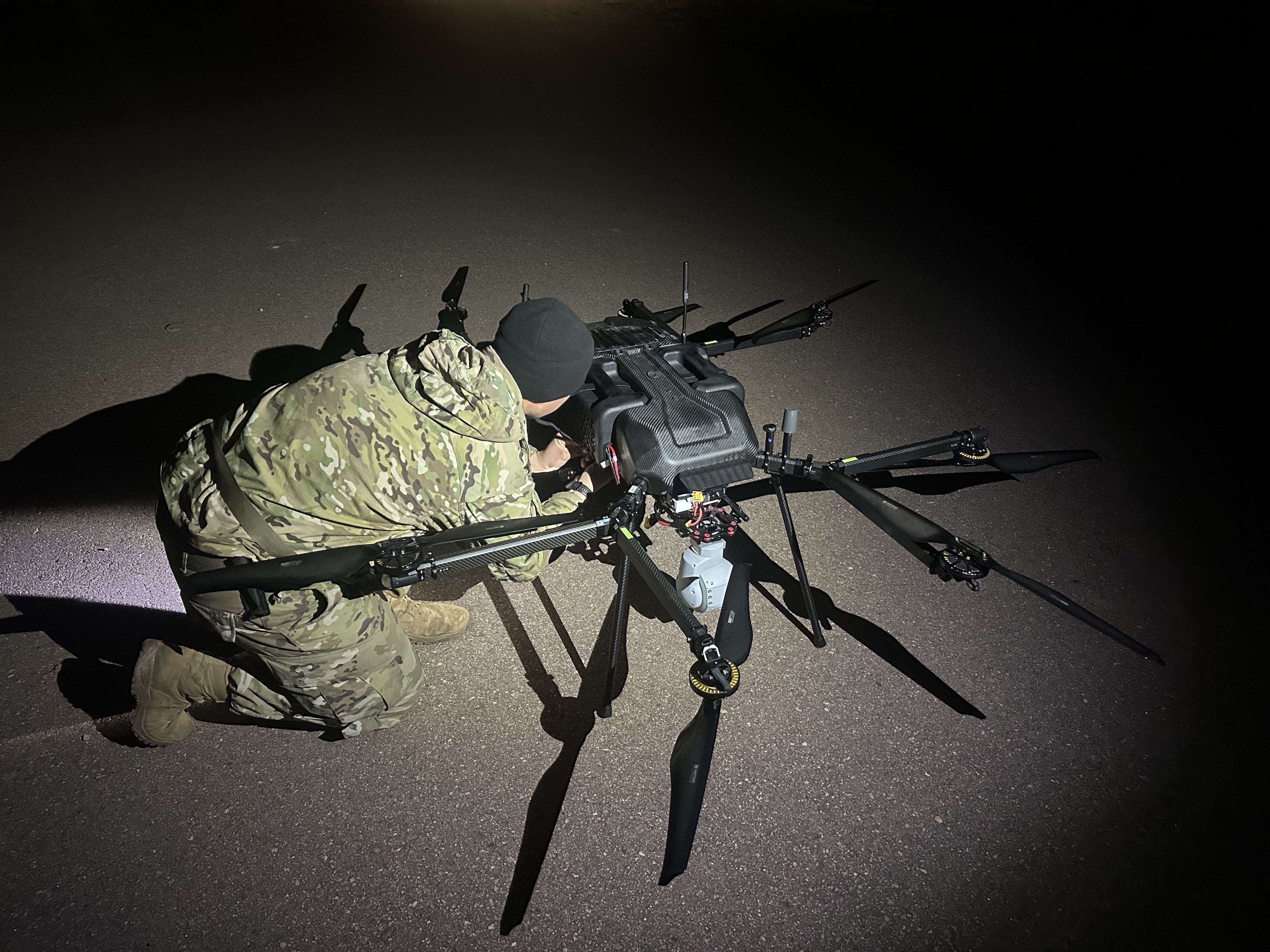 Army soldier sets up P8 hybrid drone for night flight