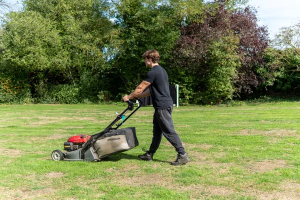 Gardener Mowing Lawn