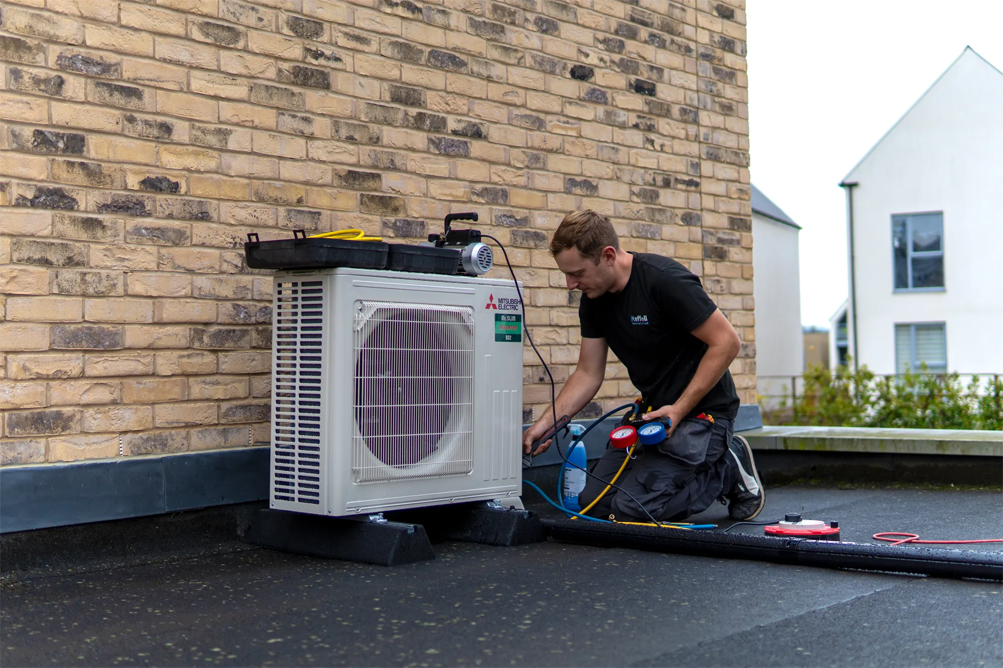 Aircon Engineer On Roof Installing Aircon