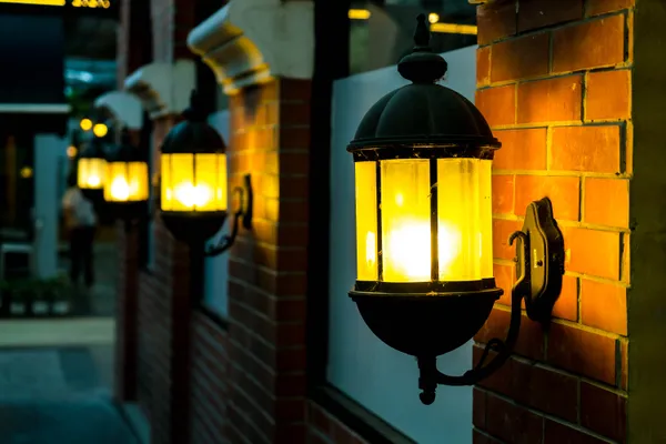 Lamp Against Red Brick Wall Night