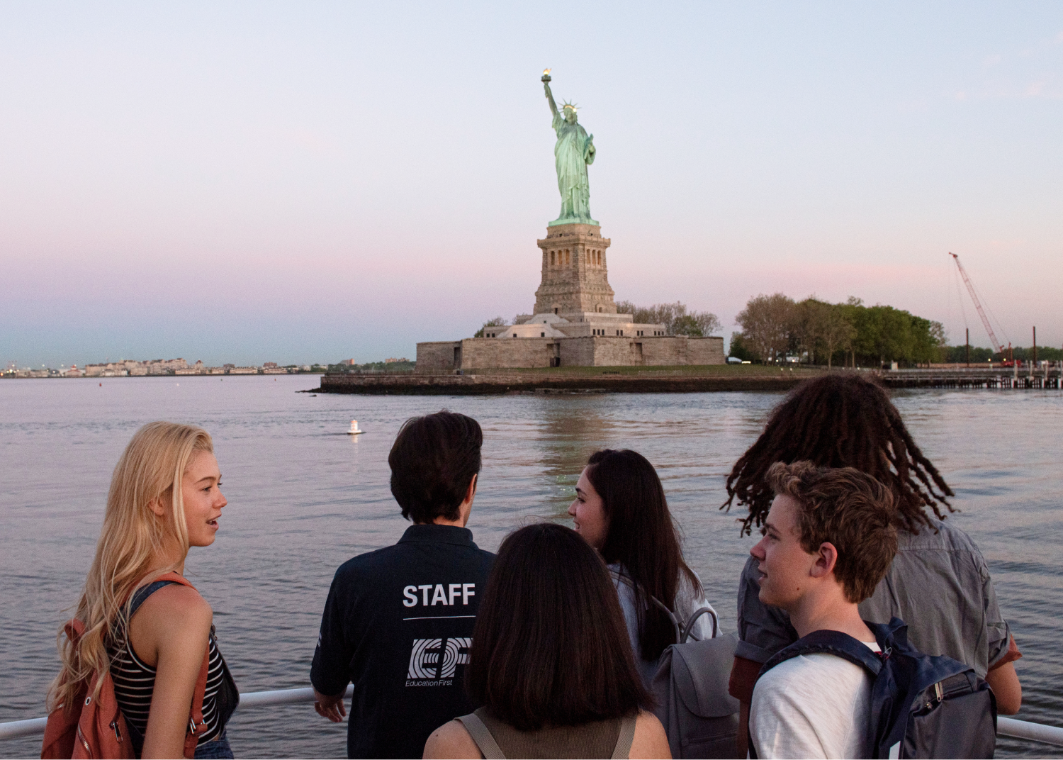 Students viewing the statue of Liberty on a tour