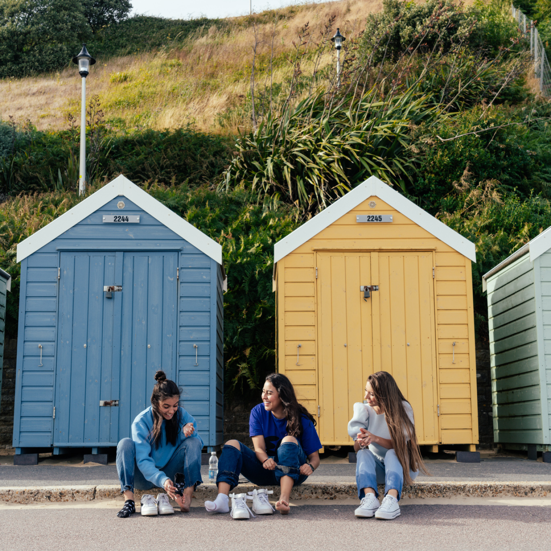 Students In front of bournemouth beach huts