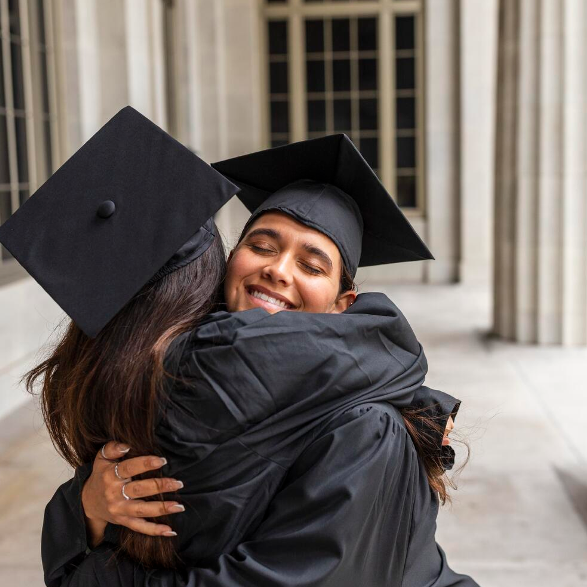 students hugging during graduation