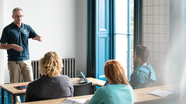 Staff And Students In Classroom