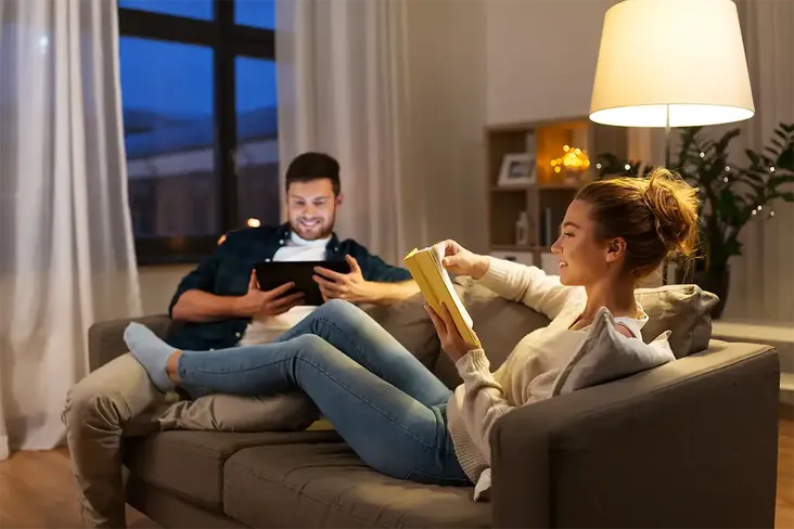 first time buyers relaxing on their sofa after comparing conveyancing fees and instructing a solicitor for their house purchase