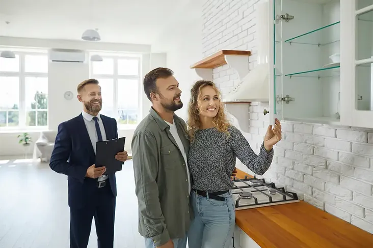a couple admiring the kitchen at a house viewing