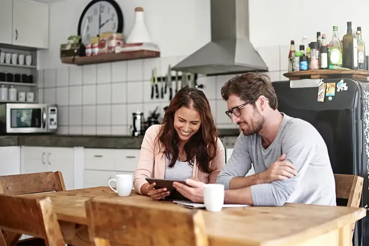 couple looking at their mortgage deal to see whether they should remortgage to release equity