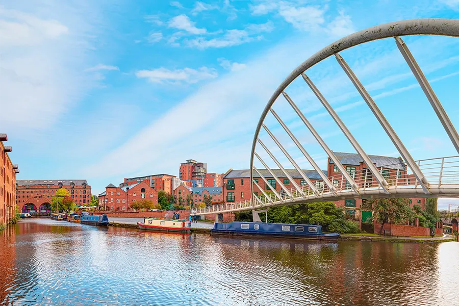 waterway canal area with modern bridge, Castlefield district Manchester, North West UK
