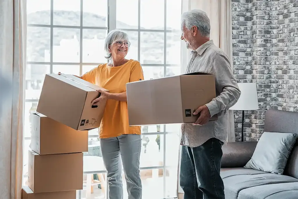 couple unpacking their belongings in their new home after relocating