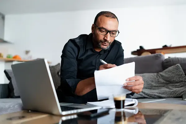 man in his 40s looking at tips for buying a house to rent out