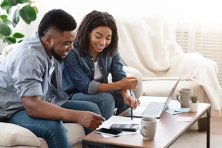 young couple using their laptop to apply for a mortgage in principle
