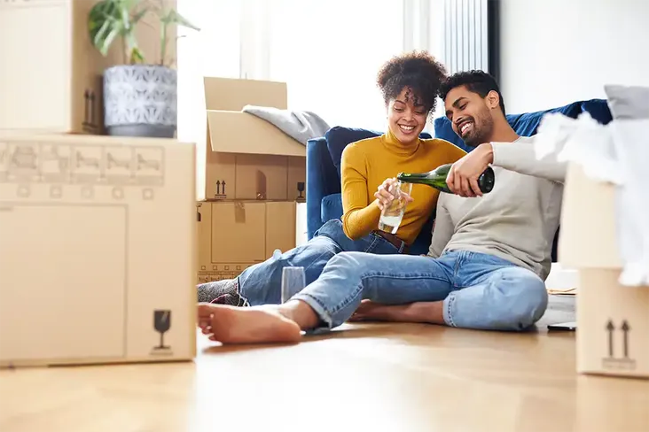 first time buyers celebrating moving into their new home