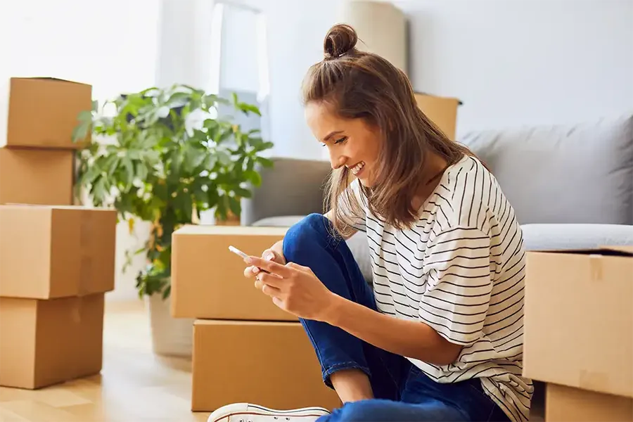 woman moving into her new home redirecting mail and choosing new home utility companies