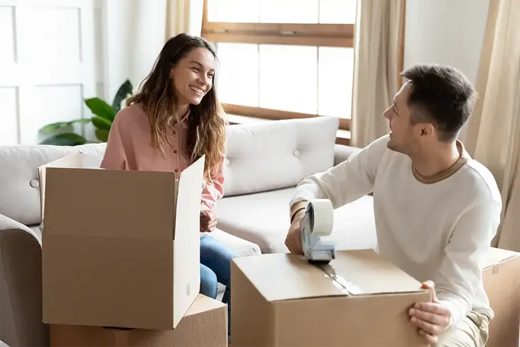 a young couple packing up their belongings ready for moving house