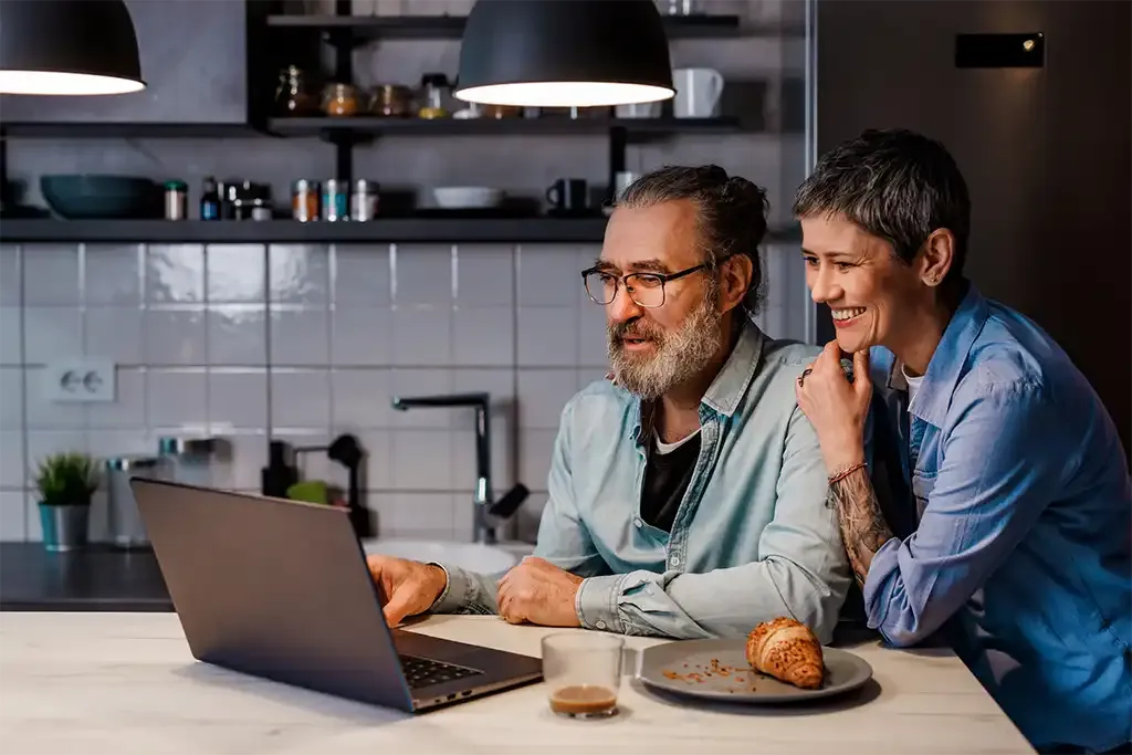 middle aged couple looking at how much money they can save on their house purchase as cash buyers