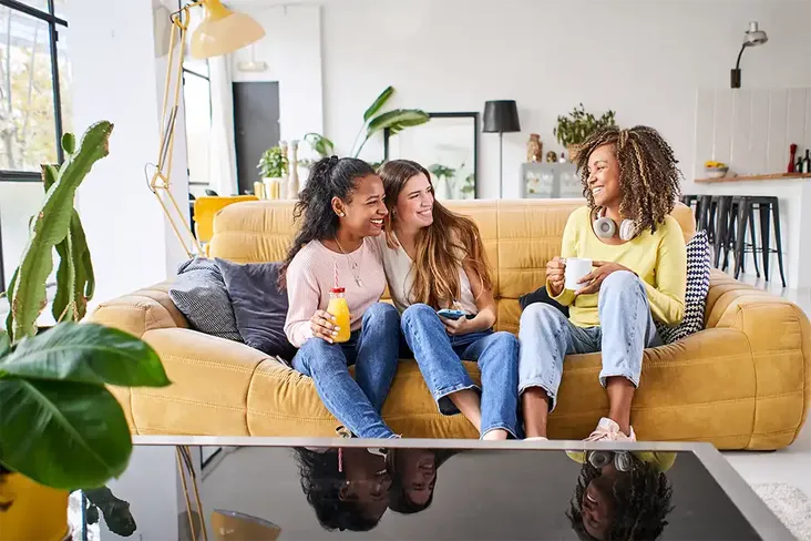 young adults celebrating buying a house together as tenants in common