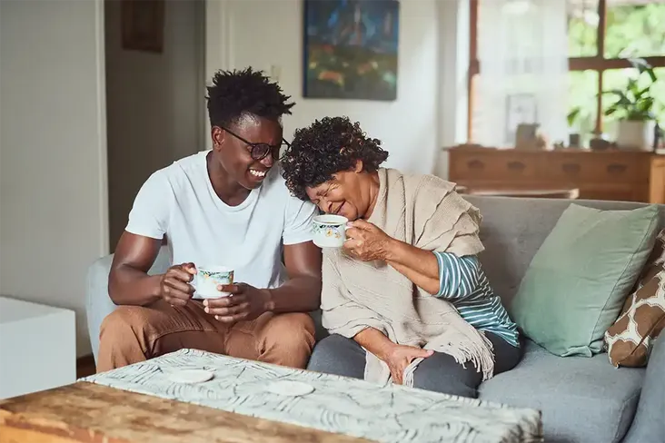 grandmother and grandson having a cup of tea after looking at the process to release equity