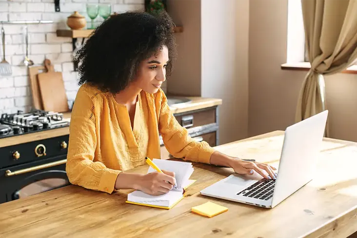 young woman going through her moving house checklist before completing on her first house purchase