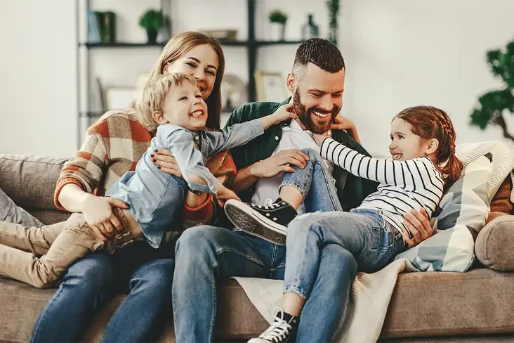 a happy family in their new how having just used a conveyancer to help them with their move