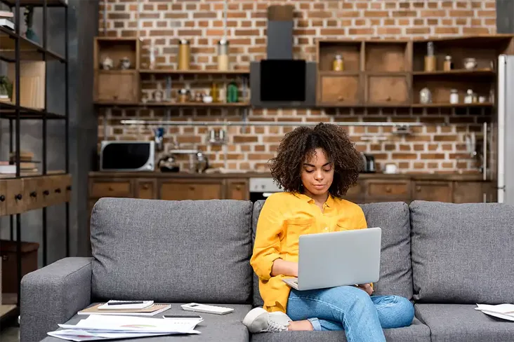 woman looking looking at her house purchase progress online to see how long left until completion