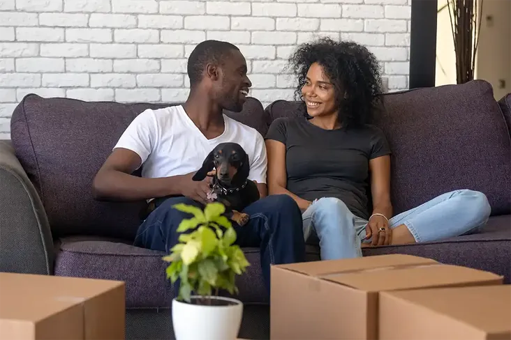 young couple discussing their upcoming long distanced move to their new home together