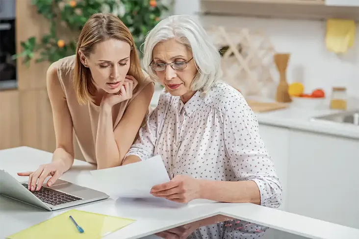 a young women and her mother looking through documents to find out more about Inheritance tax