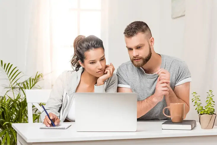 young couple concentrated looking at their options for remortgaging as their fixed contract mortgage is coming to an end