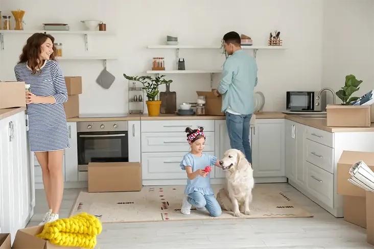 young family unpacking after a successful move into their new home