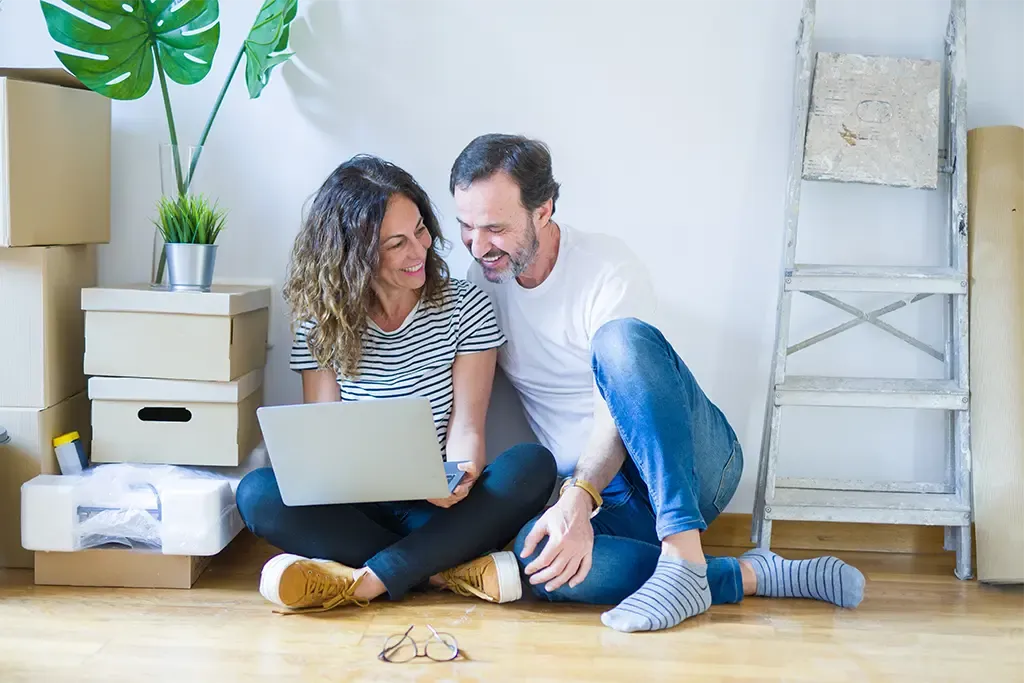 couple entering their new home address to get contents insurance