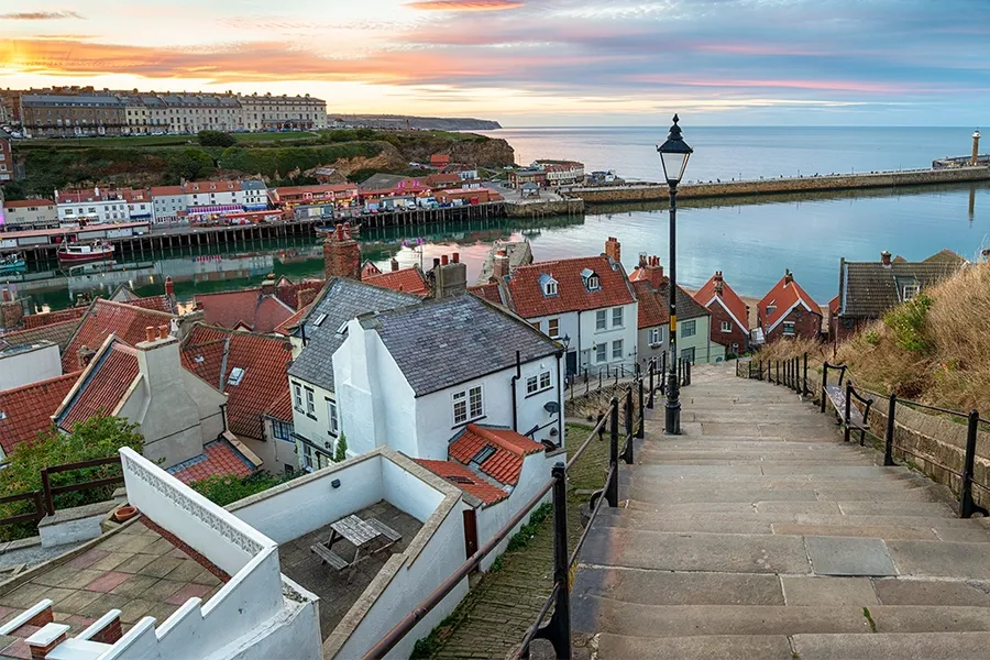 houses and sea in the sunset over Whitby Harbour