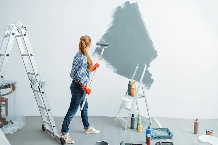 homeowner painting to add value to her home