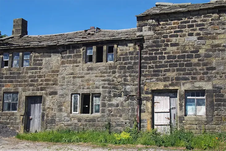 a persons view looking at a derelict house up for auction trying to understand how to buy it