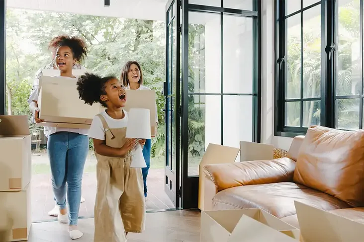excited children with mum seeing their new home on completion day