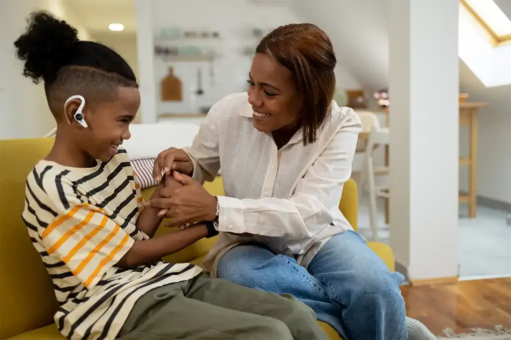 a single mum playing with her son as she celebrates becoming a homeowner after using the Right to Buy scheme