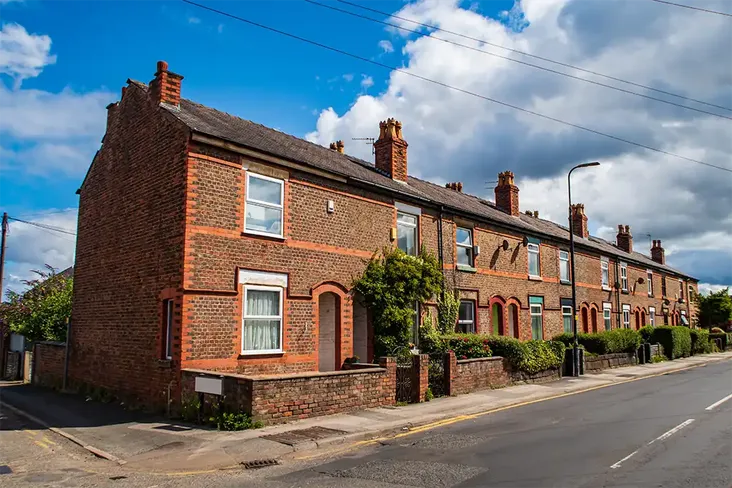 a house for auction on a street of terraced houses in manchester