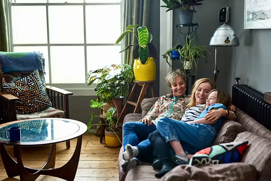 family sitting on a sofa happy in their new home