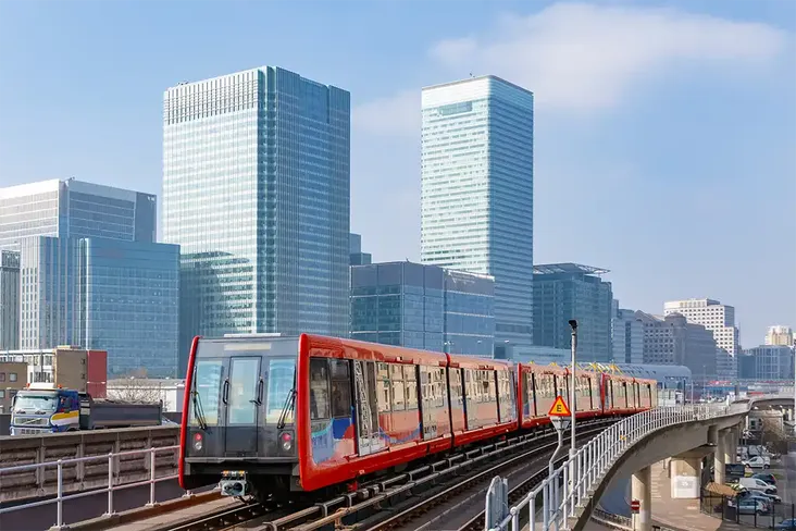 a regular sight for commuters in London the Docklands light railway with Canary Wharf in the background