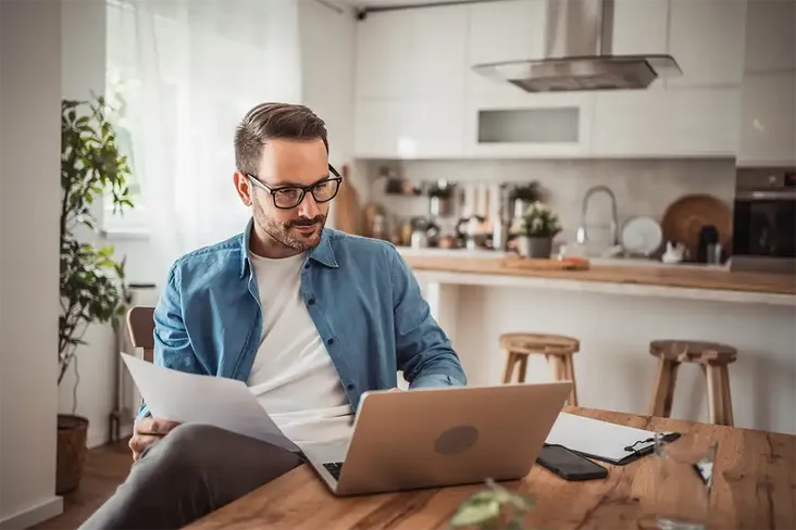 man reviewing his conveyancing paperwork to sell his rental property