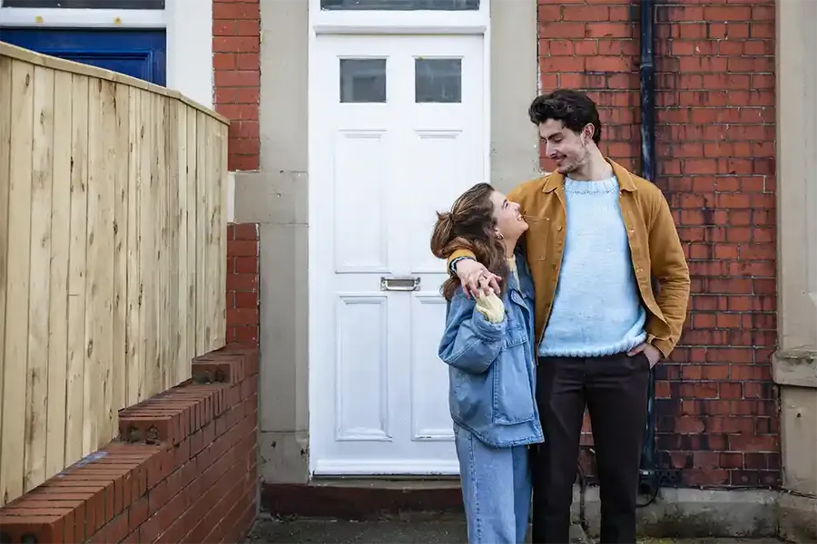 First-time buyers outside their new home in Edinburgh, Scotland