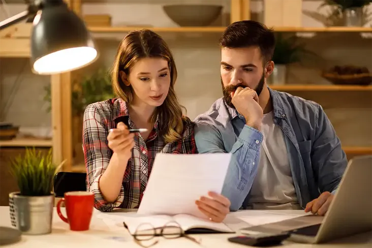 young couple working out if they can use the rent to buy scheme