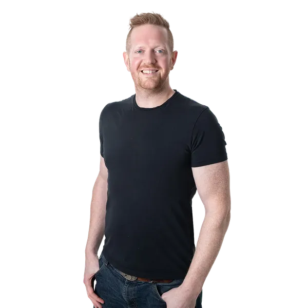 Smiling man in a black t-shirt and jeans