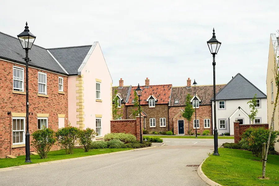 a small road of new build houses. They are quite large and made to look like older houses, each one is in a different style