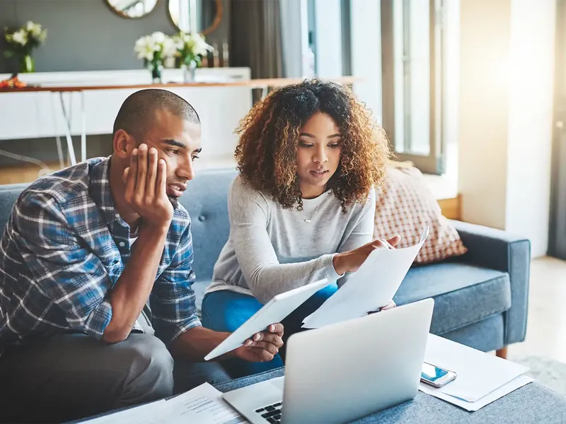 A couple looking over paperwork to find out what level survey they need